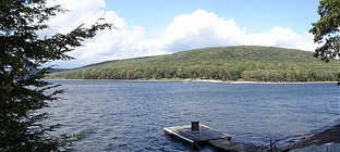 A view of Deep Creek Lake with a dock and shoreline