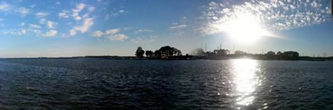 Waterfront view of Kent Narrows with docked boats and a bridge in the distance